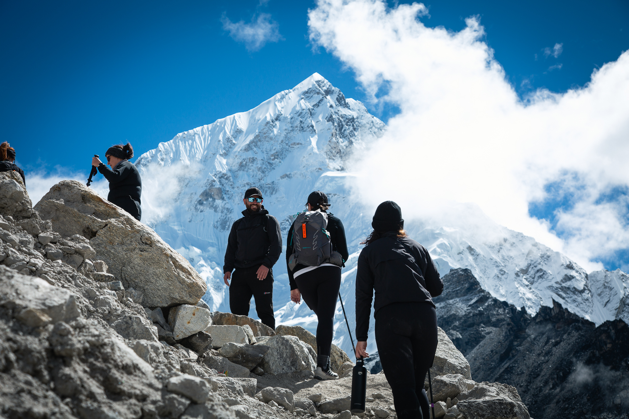 Stunning view of Mount Everest and surrounding peaks from the Everest Base Camp trail, under clear blue skies